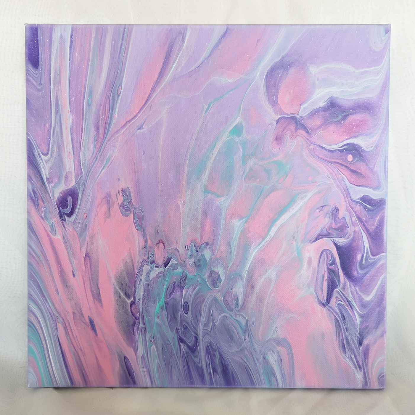 Abstract painting in pastel colors of green, purple, white, and pink.