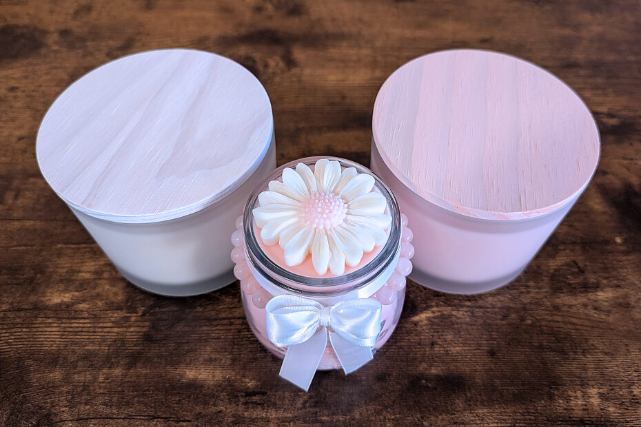 Homemade pink and white candles with wooden tops